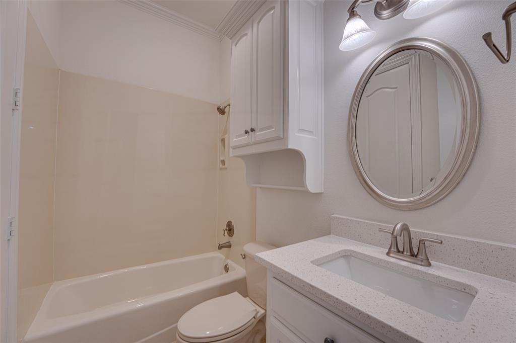 2216 Kings Pass Heath, TX 75032 - Photo 26 of 40 a bathroom with a granite countertop toilet sink and mirror