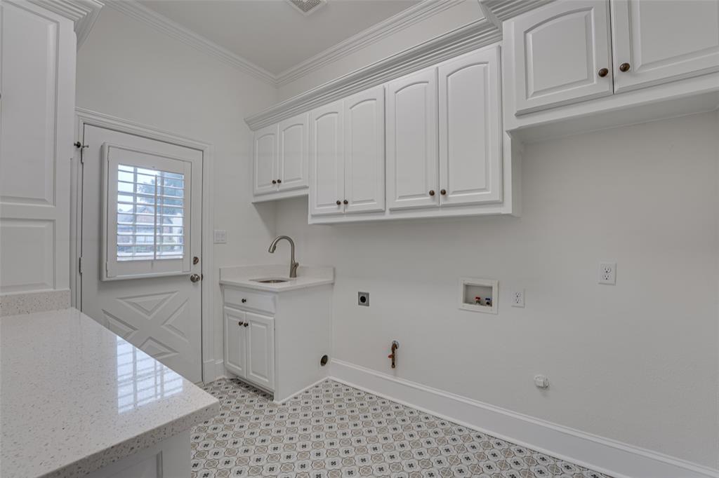 2216 Kings Pass Heath, TX 75032 - Photo 27 of 40 a room with granite countertop white cabinets and sink