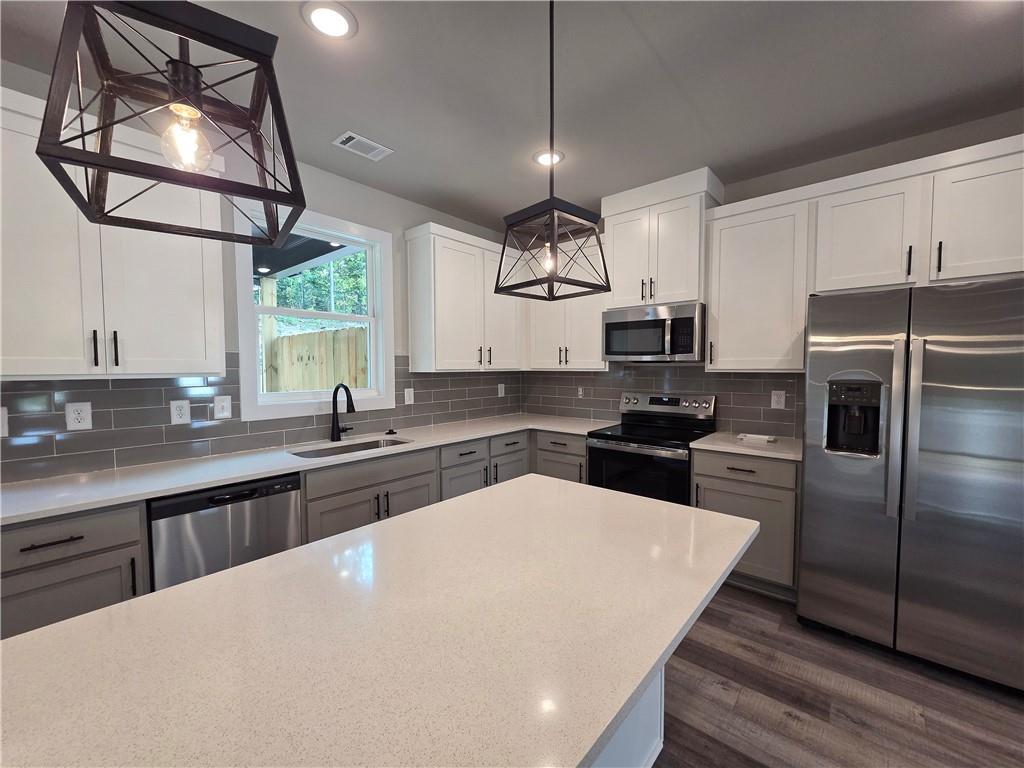 2 Rock Pk Way, Unit 13 Tucker, GA 30084 - Photo 15 of 39 a kitchen with cabinets and stainless steel appliances