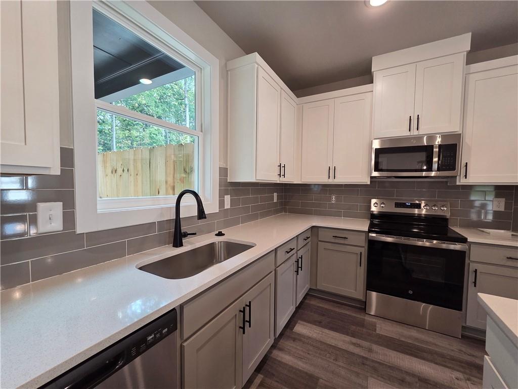 2 Rock Pk Way, Unit 13 Tucker, GA 30084 - Photo 16 of 39 a kitchen with sink a stove and cabinets