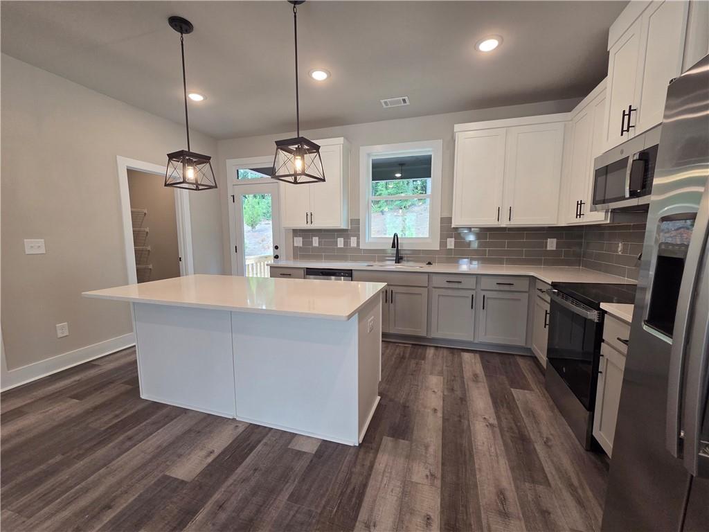 2 Rock Pk Way, Unit 13 Tucker, GA 30084 - Photo 17 of 39 a kitchen with stainless steel appliances granite countertop a sink a stove and refrigerator