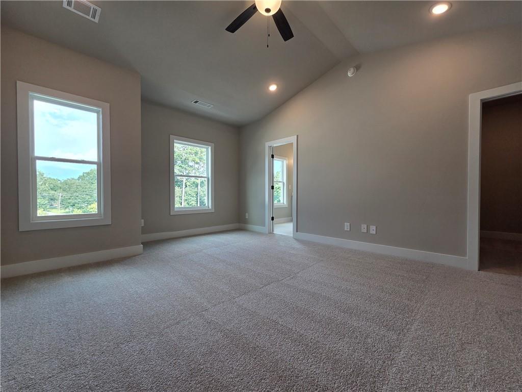 2 Rock Pk Way, Unit 13 Tucker, GA 30084 - Photo 29 of 39 an empty room with chandelier fan and windows