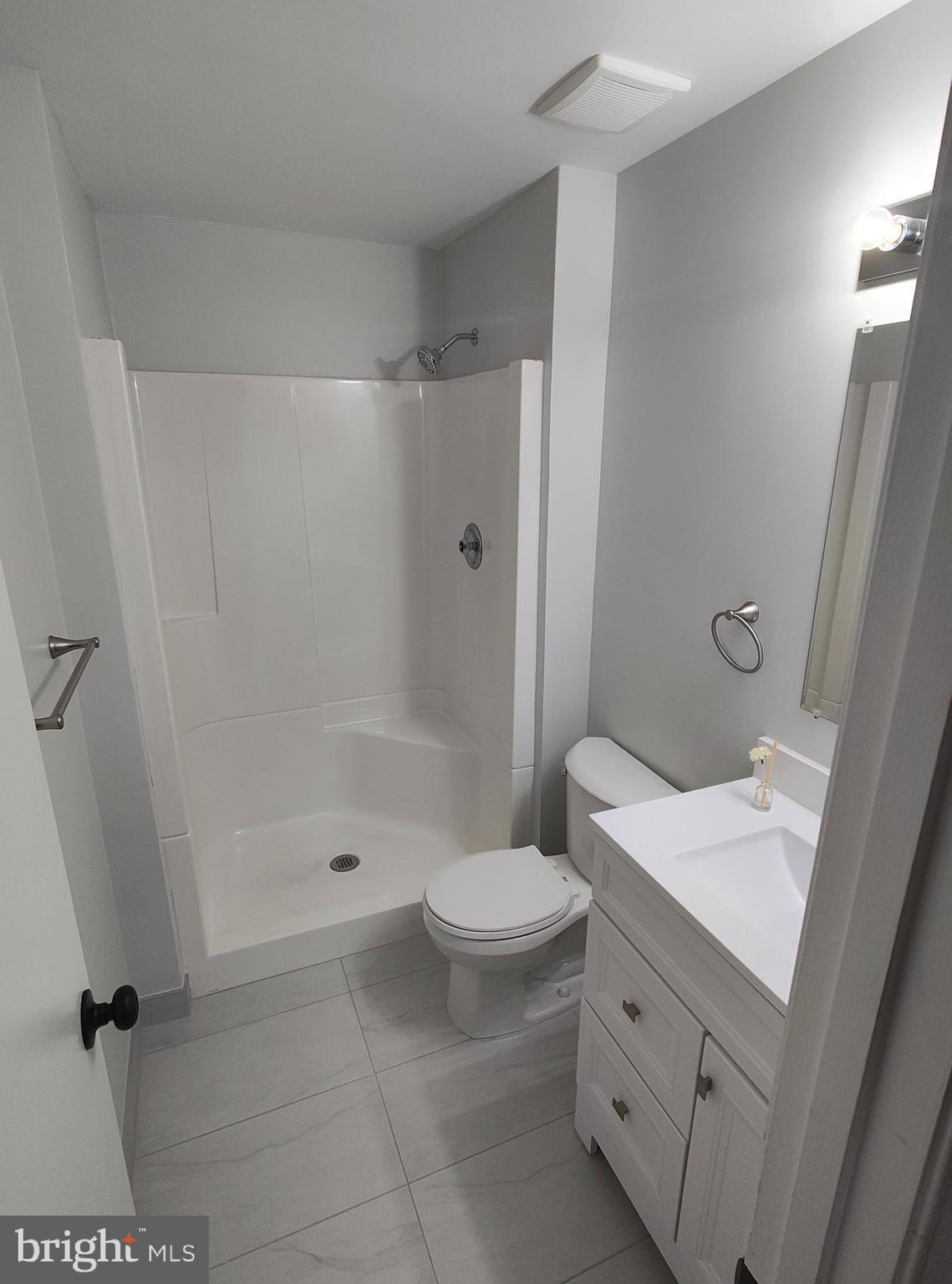 15712 Brandywine Road Dumfries, VA 22025 - Photo 12 of 15 a bathroom with a sink a toilet and shower