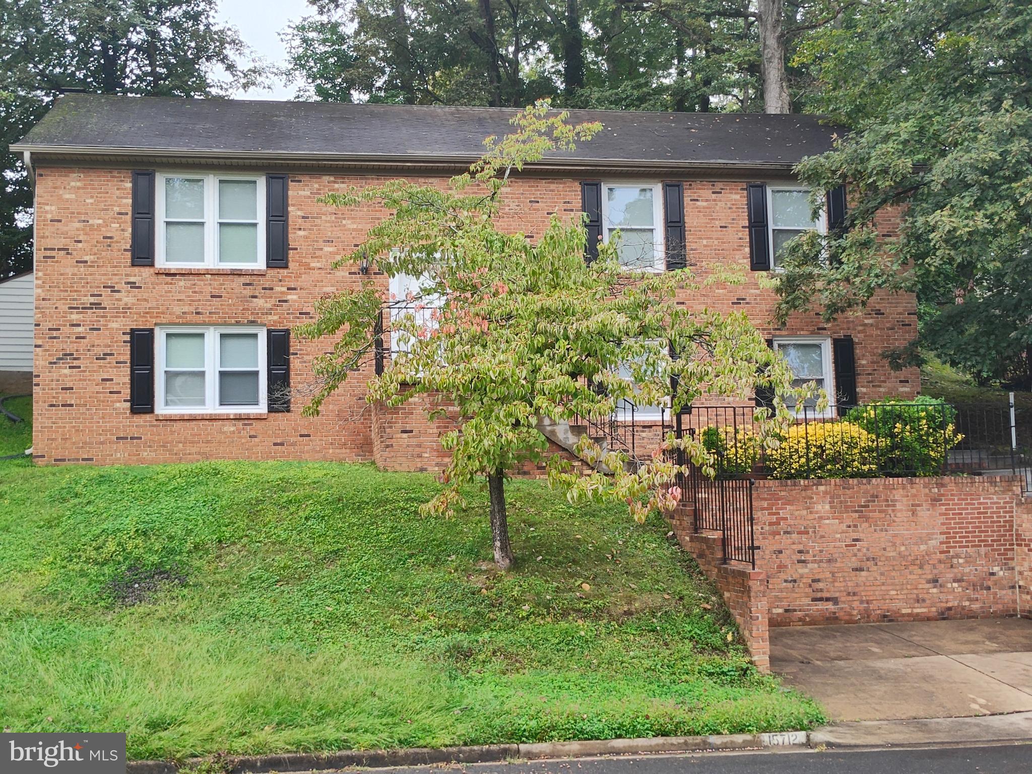 15712 Brandywine Road Dumfries, VA 22025 - Photo 2 of 15 a front view of a house with a yard
