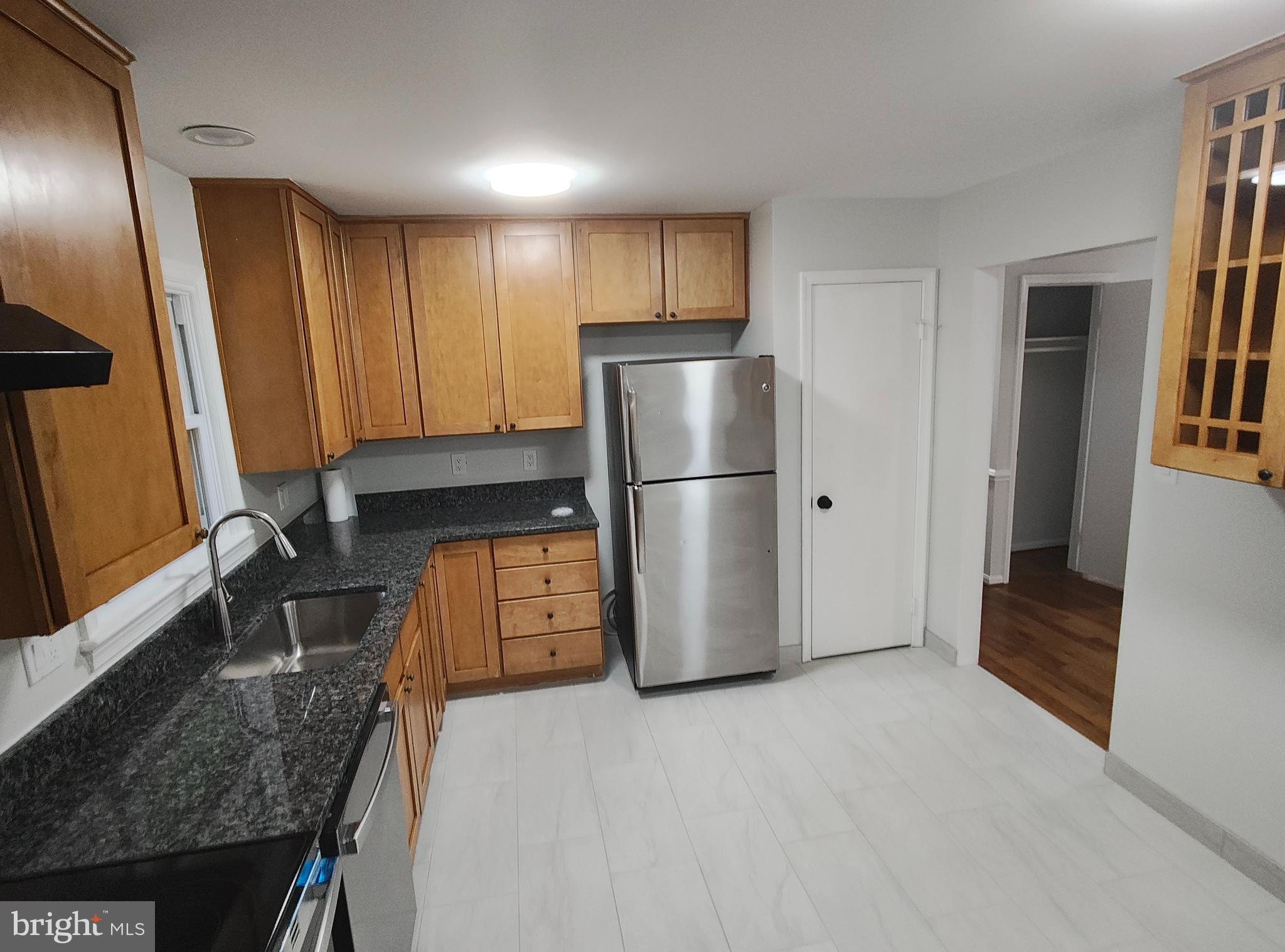 15712 Brandywine Road Dumfries, VA 22025 - Photo 3 of 15 a kitchen with a refrigerator a stove and a sink