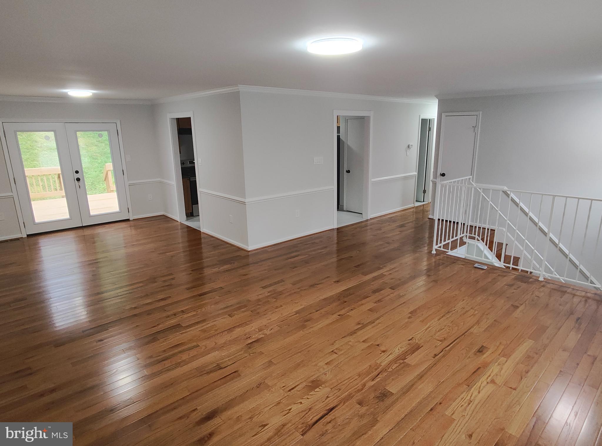 15712 Brandywine Road Dumfries, VA 22025 - Photo 4 of 15 an empty room with wooden floor and windows