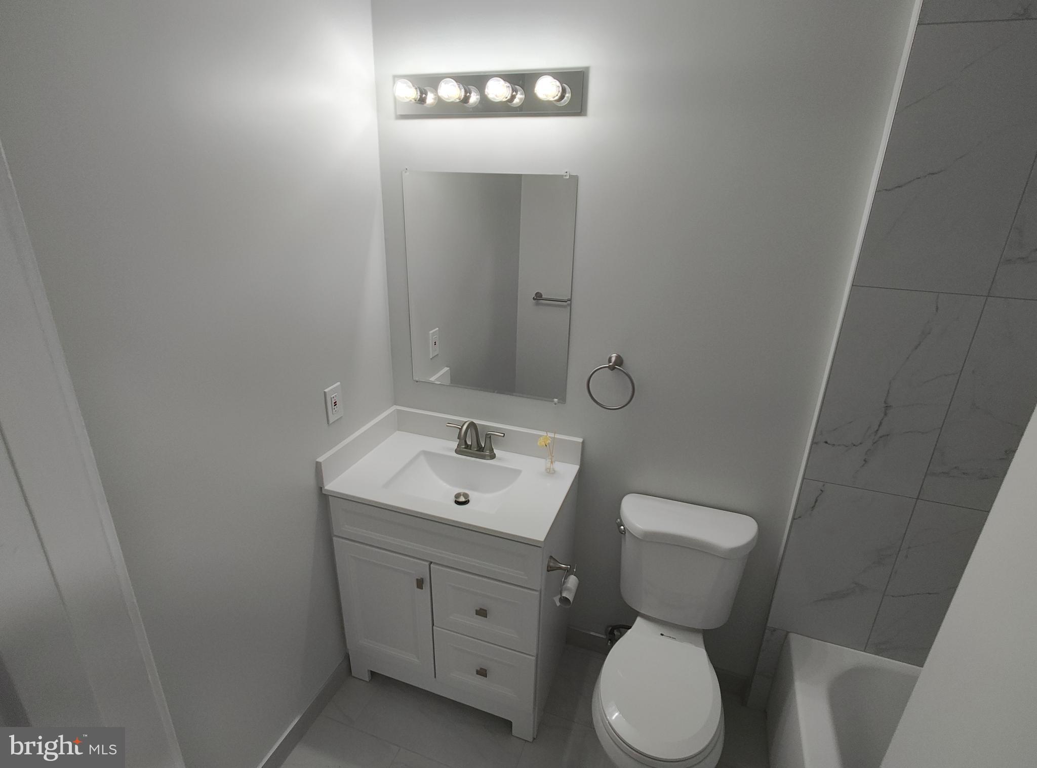 15712 Brandywine Road Dumfries, VA 22025 - Photo 6 of 15 a bathroom with a toilet sink and mirror