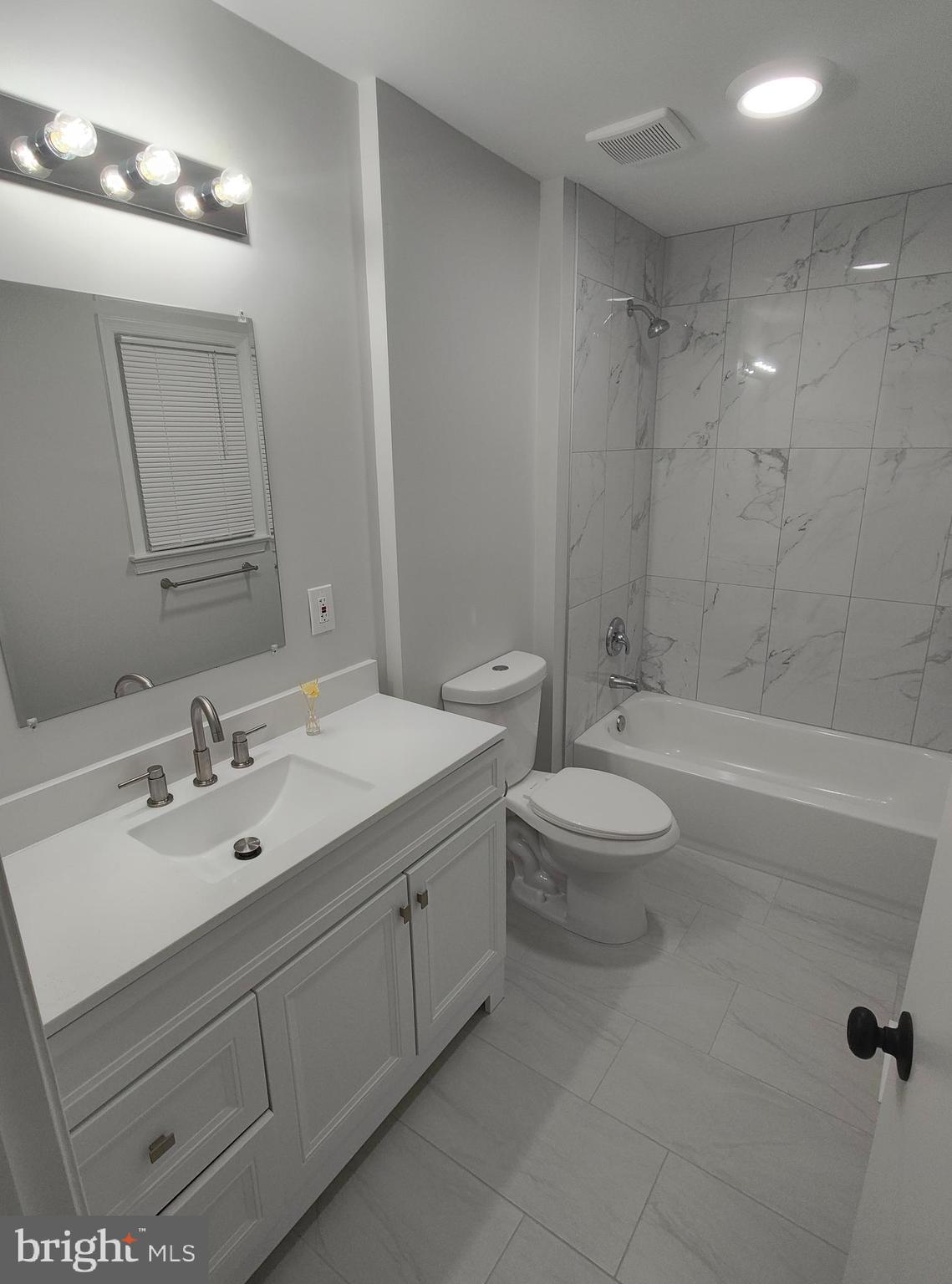 15712 Brandywine Road Dumfries, VA 22025 - Photo 8 of 15 a bathroom with a double vanity sink toilet mirror and bathtub