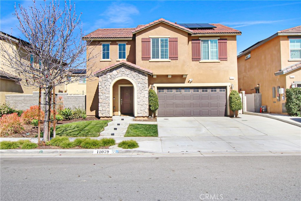11079 Longfield Lane Eastvale, CA 91752 - Photo 1 of 16 a front view of a house with a yard and garage