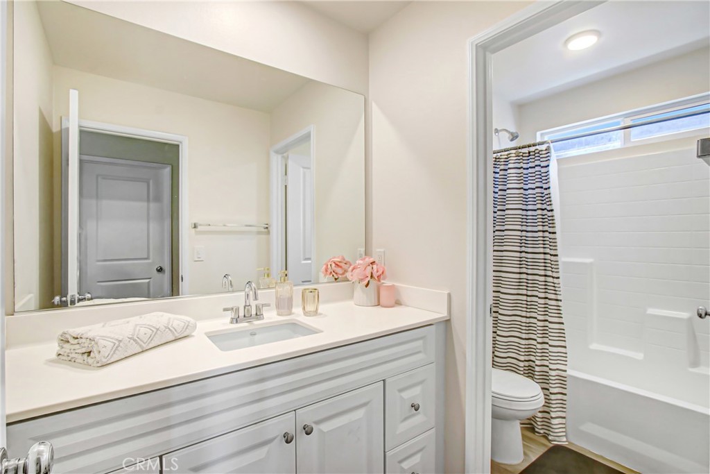 11079 Longfield Lane Eastvale, CA 91752 - Photo 12 of 16 a bathroom with a sink a toilet and shower