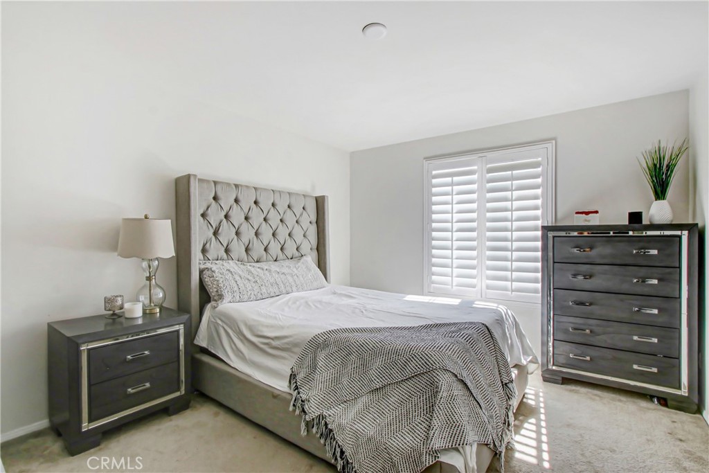 11079 Longfield Lane Eastvale, CA 91752 - Photo 13 of 16 a bedroom with a bed and a dresser