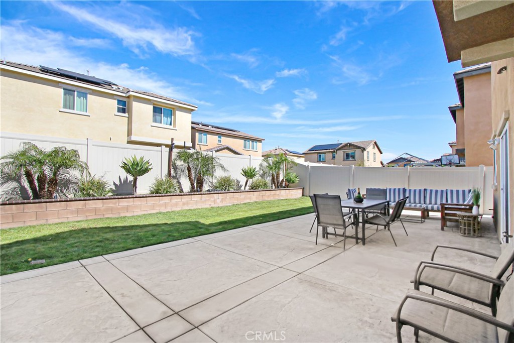 11079 Longfield Lane Eastvale, CA 91752 - Photo 14 of 16 a view of a patio with table and chairs and potted plants