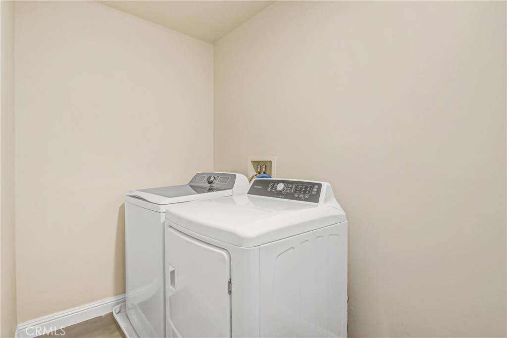 11079 Longfield Lane Eastvale, CA 91752 - Photo 16 of 16 a utility room with dryer and washer