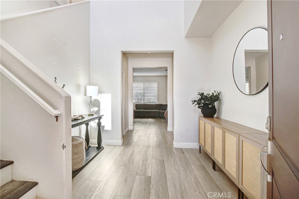 11079 Longfield Lane Eastvale, CA 91752 - Photo 2 of 16 a view of a hallway view with wooden floor and staircase