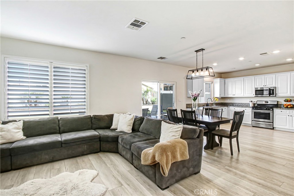 11079 Longfield Lane Eastvale, CA 91752 - Photo 4 of 16 a living room with furniture and a large window