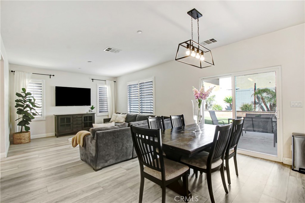 11079 Longfield Lane Eastvale, CA 91752 - Photo 5 of 16 a view of a dining room with furniture window and wooden floor