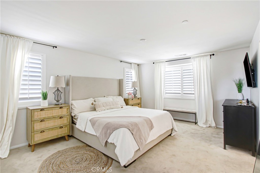 11079 Longfield Lane Eastvale, CA 91752 - Photo 9 of 16 a bedroom with a bed and a flat screen tv