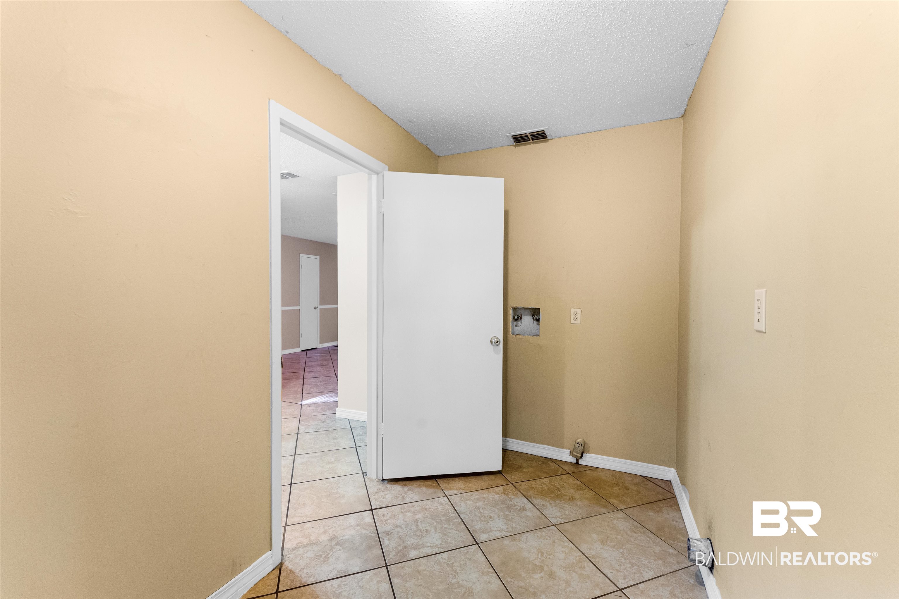 5551 Springer Court Theodore, AL 36582 - Photo 23 of 37 Washroom with a textured ceiling, hookup for a washing machine, and light tile patterned flooring
