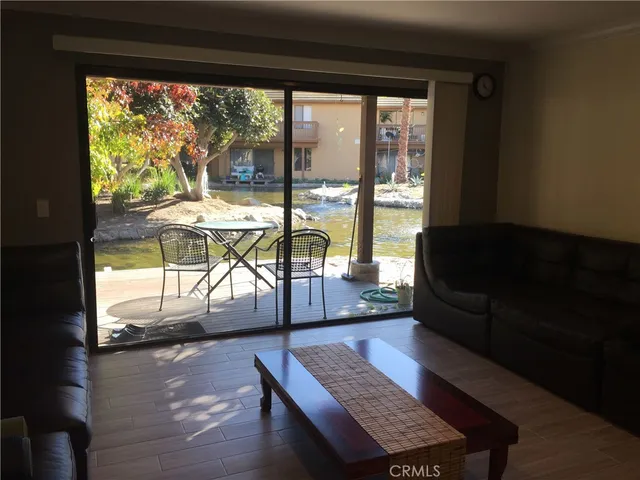 a living room with furniture and a floor to ceiling window