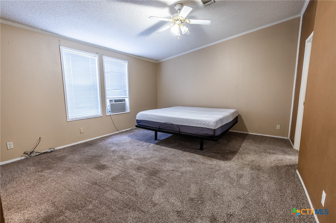 5526 Farm To Market 20 Seguin, TX 78155 - Photo 16 of 18 a living room with a window and ceiling fan