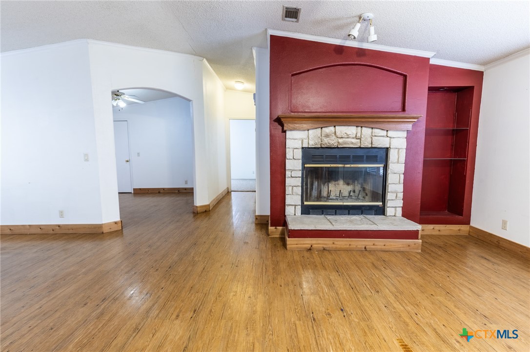 5526 Farm To Market 20 Seguin, TX 78155 - Photo 5 of 18 a living room with wooden floor and a fireplace