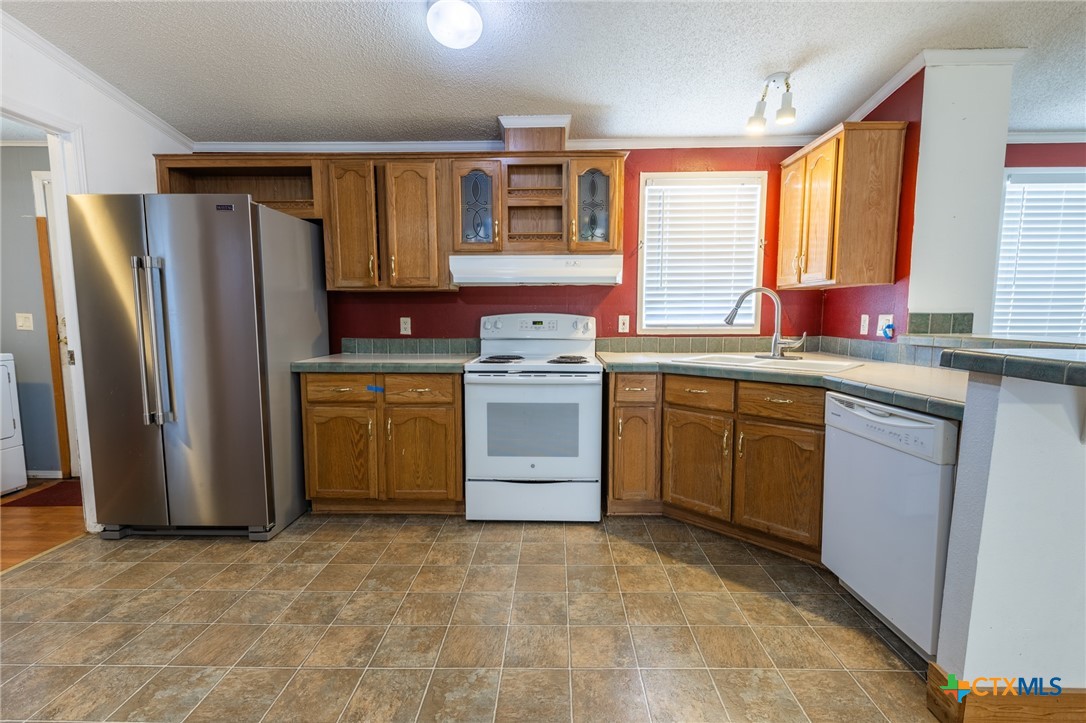 5526 Farm To Market 20 Seguin, TX 78155 - Photo 10 of 18 a kitchen with a sink stove and refrigerator