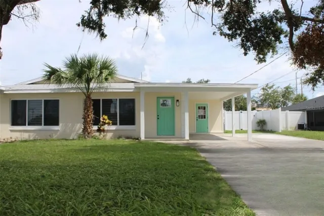 a front view of house with yard and green space