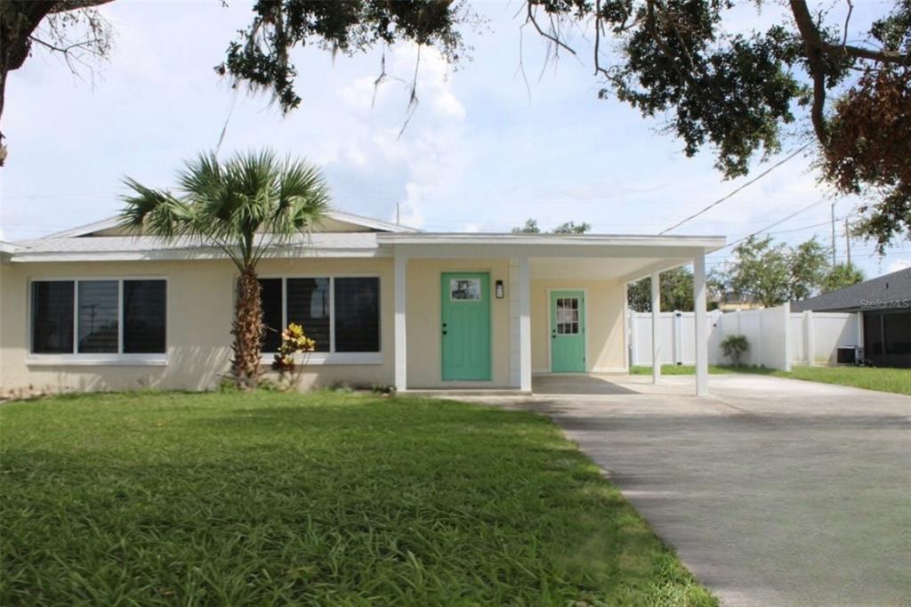 a front view of house with yard and green space