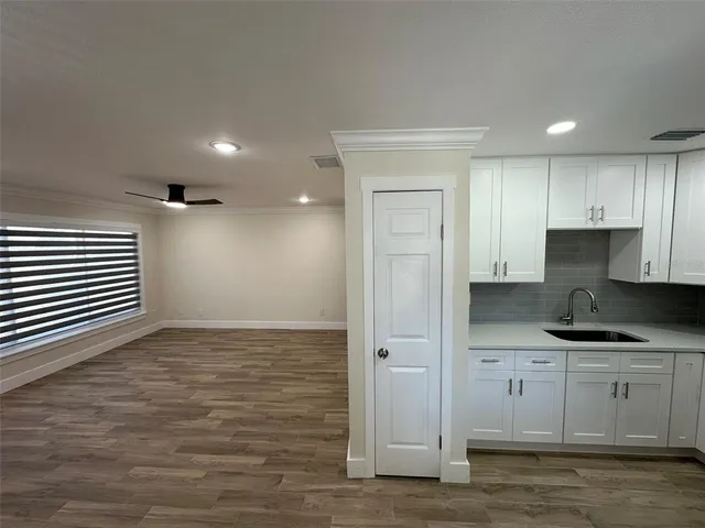 a kitchen with granite countertop a sink and a stove top oven