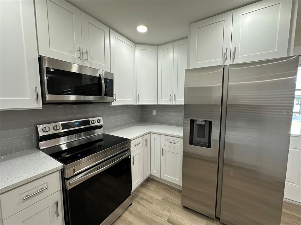 6013 Fortune Place, Unit 6013 Apollo Beach, FL 33572 - Photo 16 of 38 a kitchen with a refrigerator stove and microwave