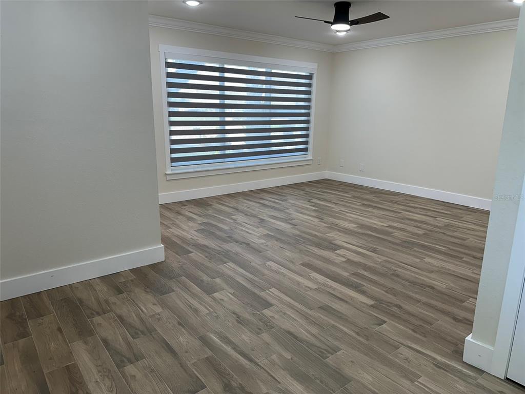 6013 Fortune Place, Unit 6013 Apollo Beach, FL 33572 - Photo 21 of 38 wooden floor in an empty room with a window