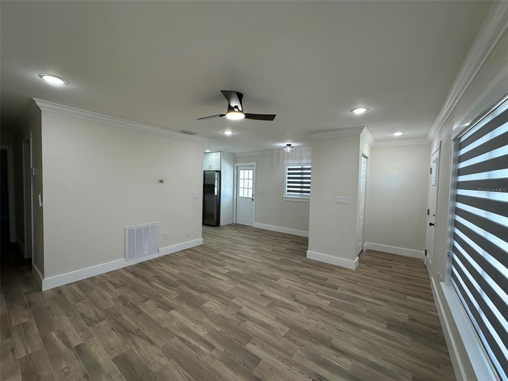 6013 Fortune Place, Unit 6013 Apollo Beach, FL 33572 - Photo 22 of 38 wooden floor in an empty room with a window