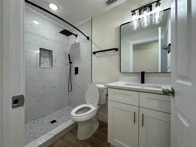 a bathroom with a toilet sink and shower