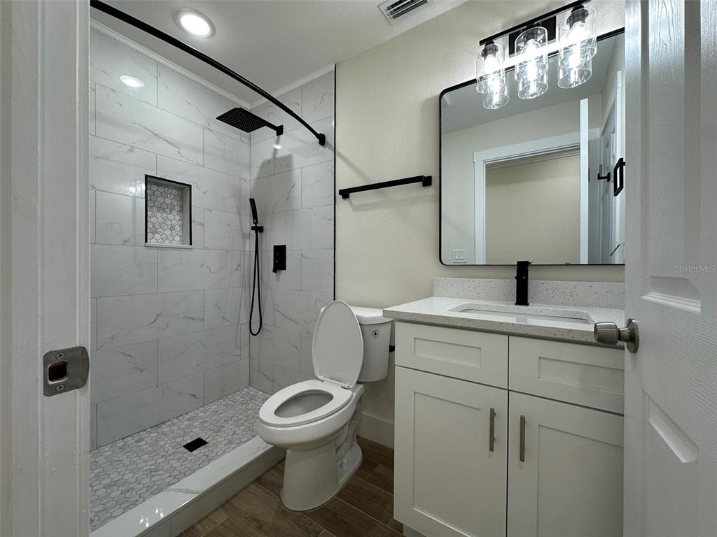 6013 Fortune Place, Unit 6013 Apollo Beach, FL 33572 - Photo 26 of 38 a bathroom with a toilet sink and shower