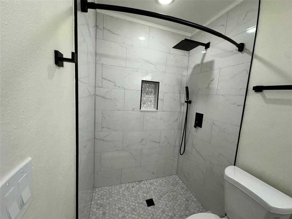 6013 Fortune Place, Unit 6013 Apollo Beach, FL 33572 - Photo 27 of 38 a bathroom with a shower and toilet