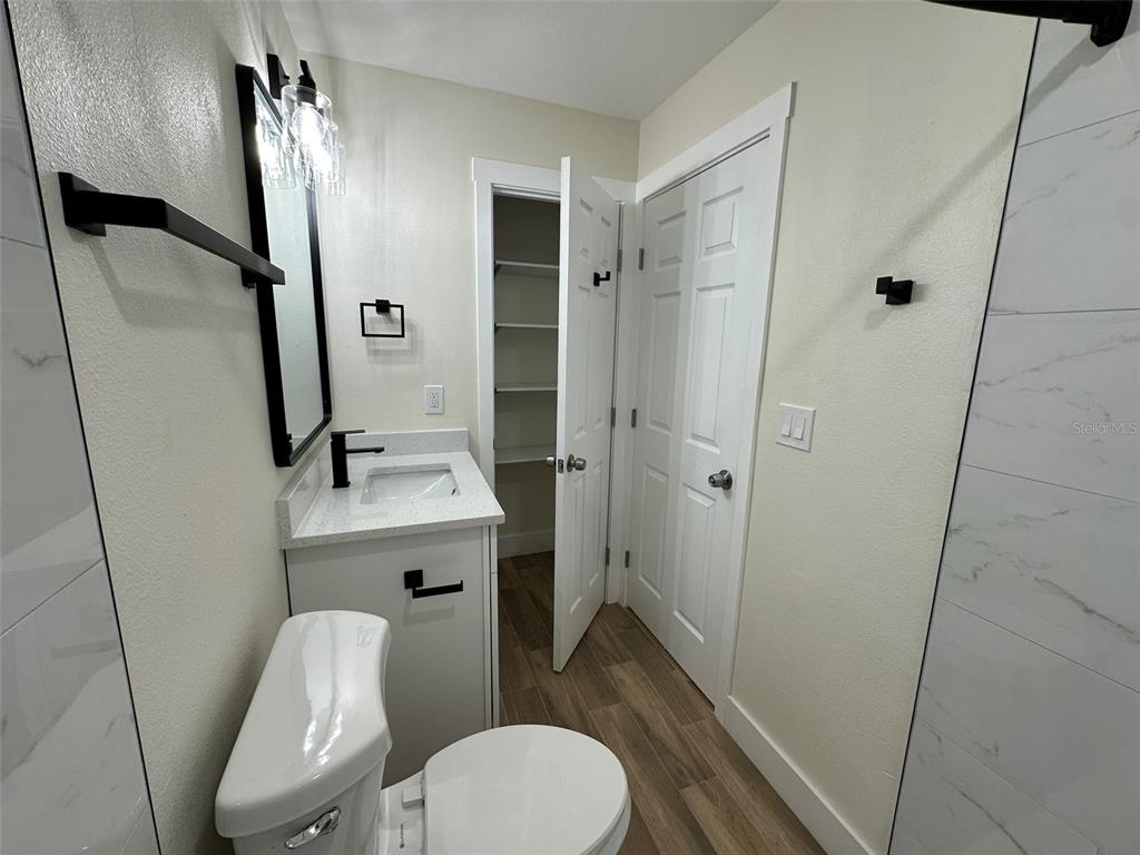 6013 Fortune Place, Unit 6013 Apollo Beach, FL 33572 - Photo 28 of 38 a bathroom with a sink a toilet a mirror and shower