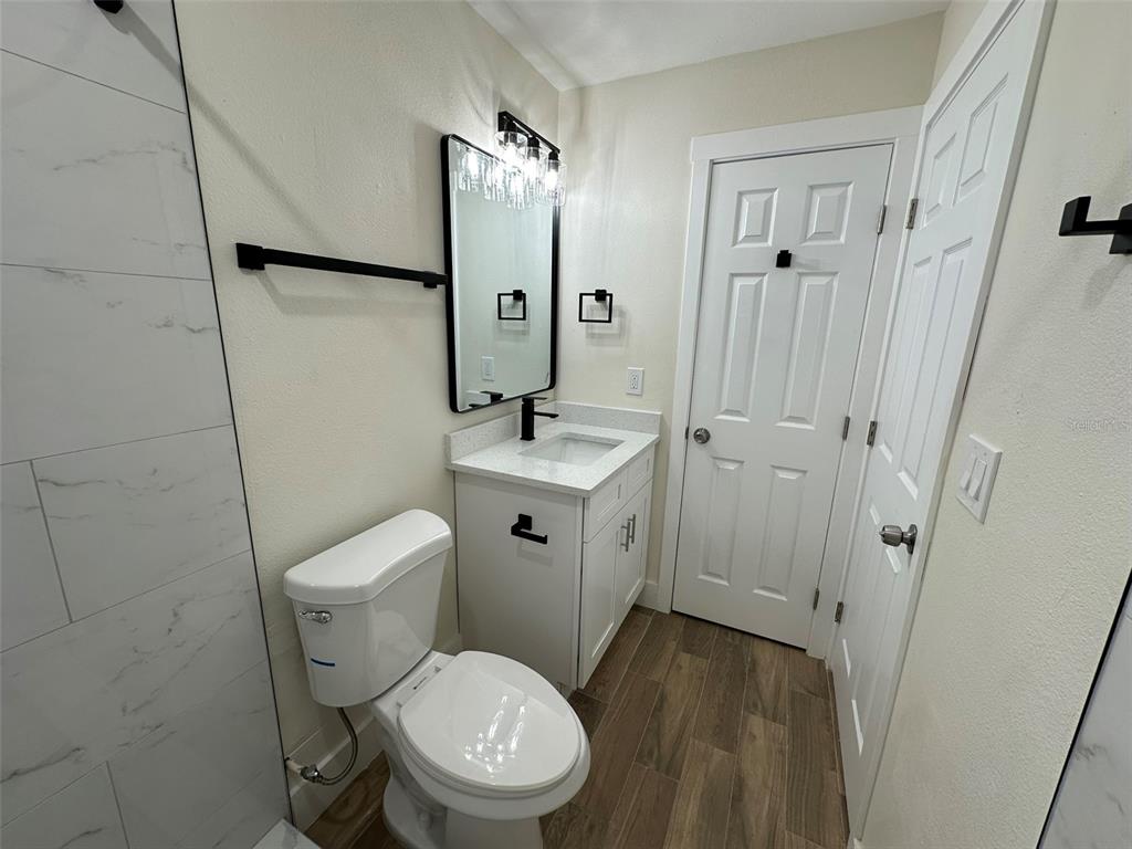 6013 Fortune Place, Unit 6013 Apollo Beach, FL 33572 - Photo 29 of 38 a white toilet sitting next to a bathroom sink