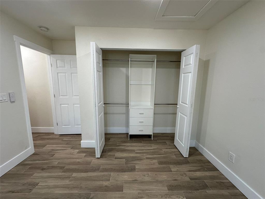 6013 Fortune Place, Unit 6013 Apollo Beach, FL 33572 - Photo 31 of 38 an empty room with wooden floor and closet