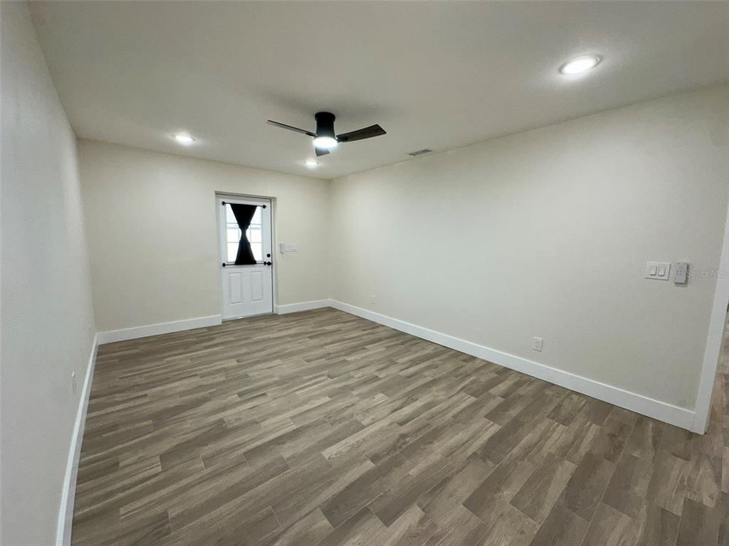 6013 Fortune Place, Unit 6013 Apollo Beach, FL 33572 - Photo 32 of 38 an empty room with wooden floor and windows