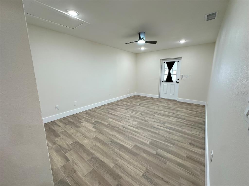 6013 Fortune Place, Unit 6013 Apollo Beach, FL 33572 - Photo 34 of 38 an empty room with windows and ceiling fan