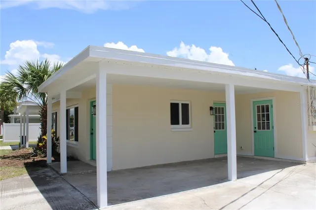 a front view of house with outdoor seating and garden