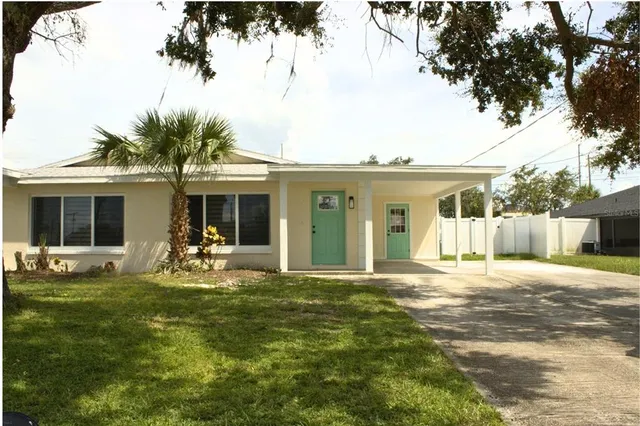 a view of a house with patio yard and sitting area