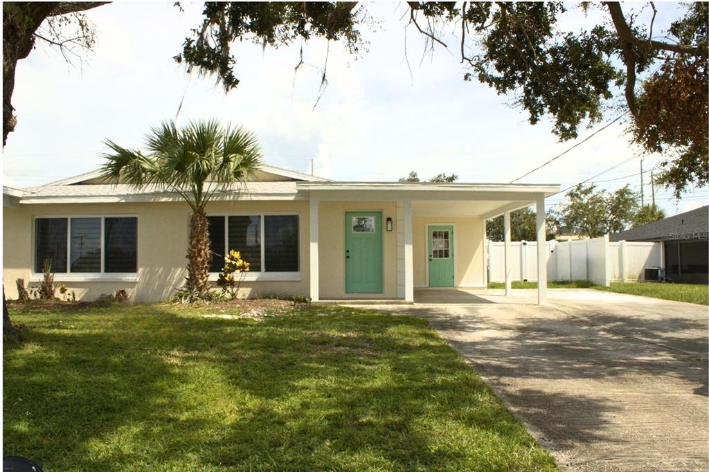 6013 Fortune Place, Unit 6013 Apollo Beach, FL 33572 - Photo 37 of 38 a front view of house with outdoor seating and garden