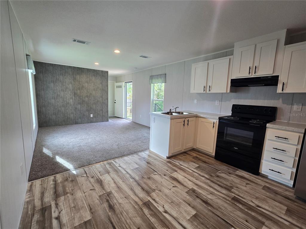 24048 Ermine Road Astor, FL 32102 - Photo 12 of 20 a view of a kitchen with electric appliances