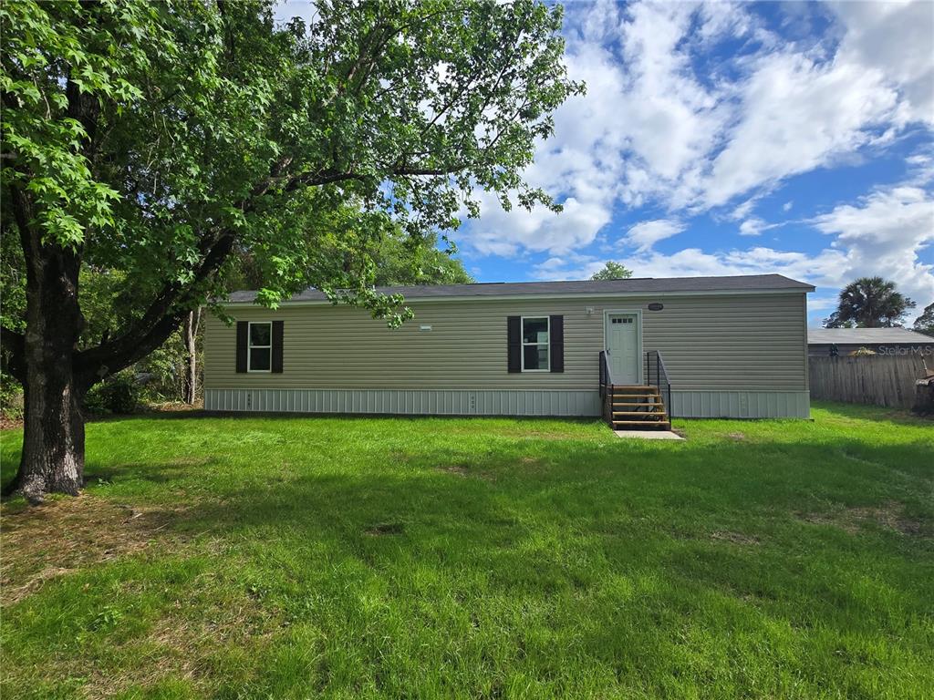 24048 Ermine Road Astor, FL 32102 - Photo 19 of 20 a house view with a garden space