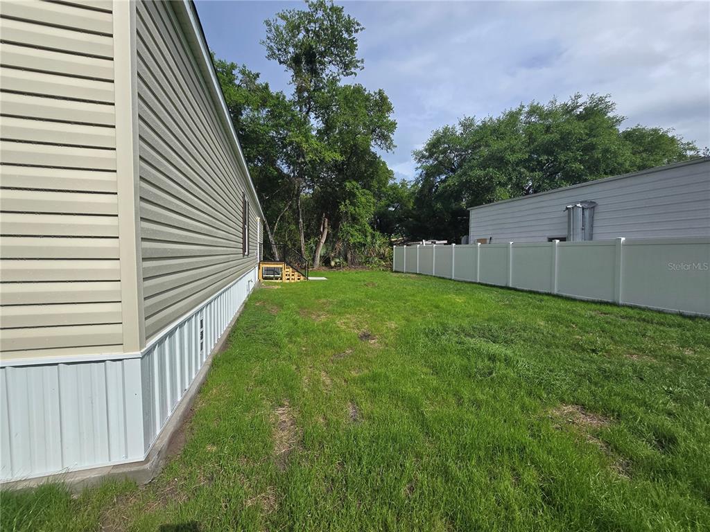 24048 Ermine Road Astor, FL 32102 - Photo 2 of 20 a backyard of a house with lots of green space