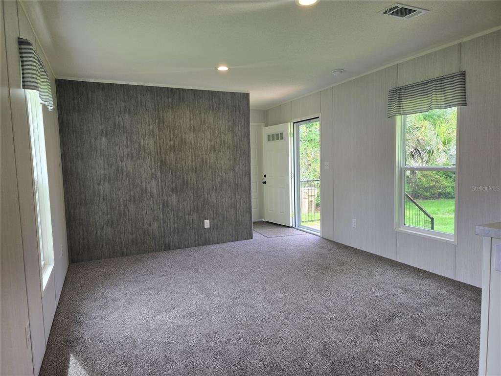24048 Ermine Road Astor, FL 32102 - Photo 7 of 20 an empty room with windows