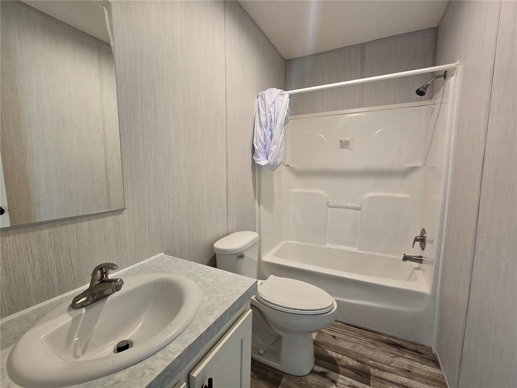 24048 Ermine Road Astor, FL 32102 - Photo 10 of 20 a bathroom with a sink toilet and shower
