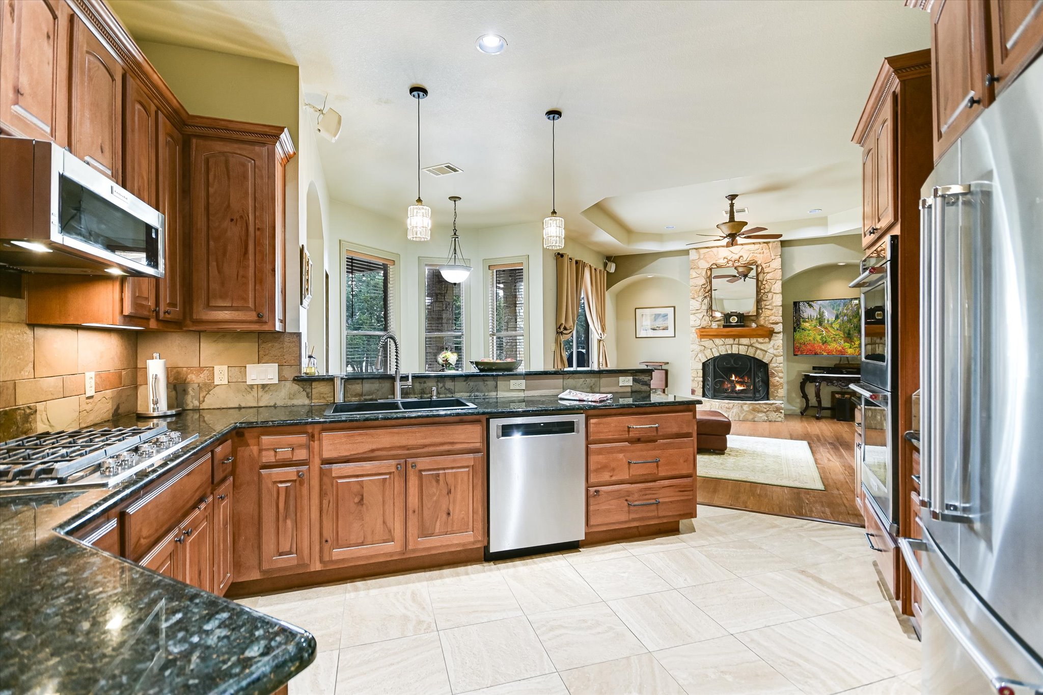 117 View Drive Georgetown, TX 78628 - Photo 16 of 40 Kitchen featuring updated stainless steel Kitchenaid appliances, pendant lighting, and dark stone countertops. Refrigerator conveys.