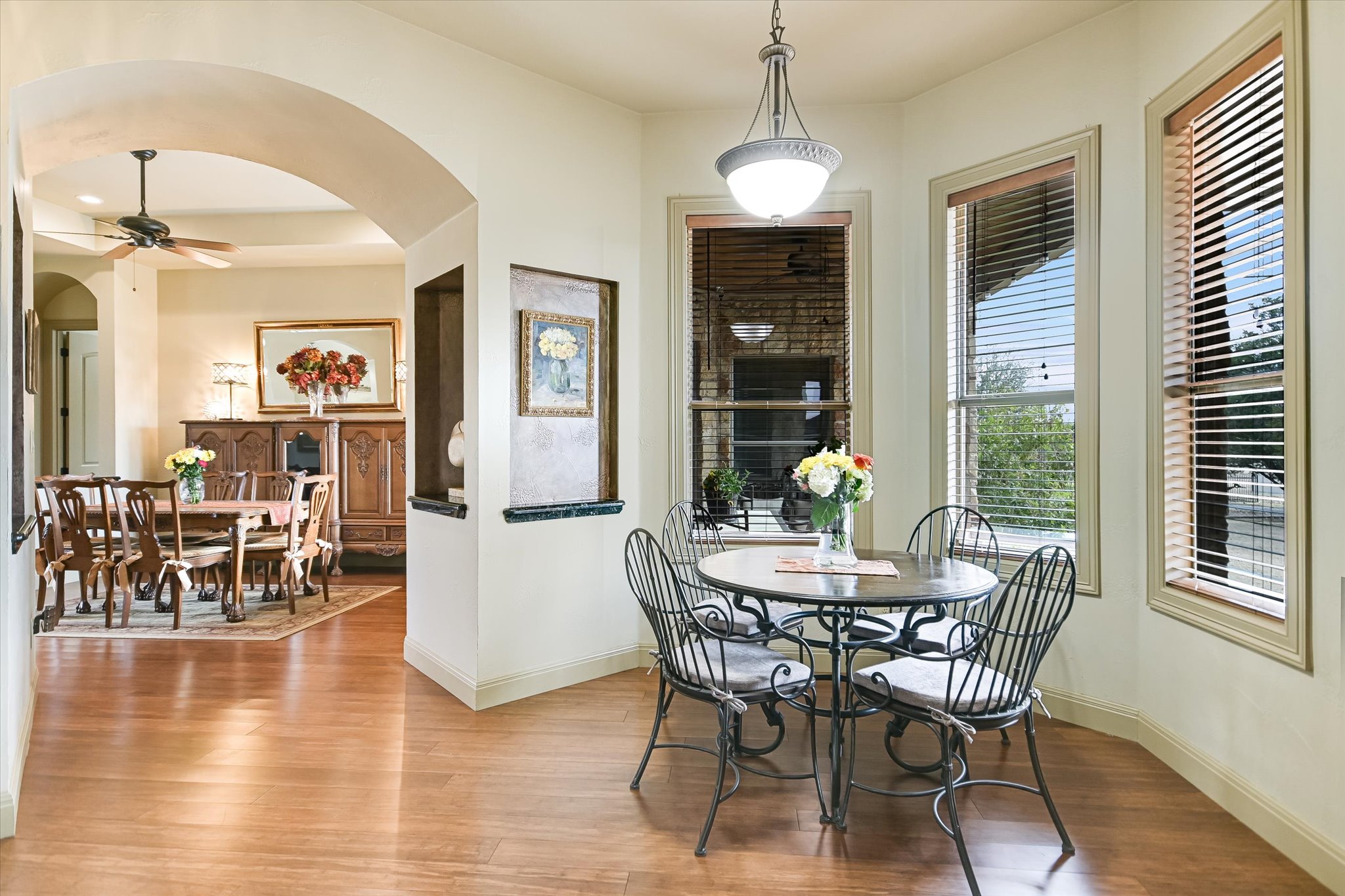 117 View Drive Georgetown, TX 78628 - Photo 17 of 40 Breakfast space featuring arched walkways, wood finished floors, chandelier, and views to covered patio and yard.